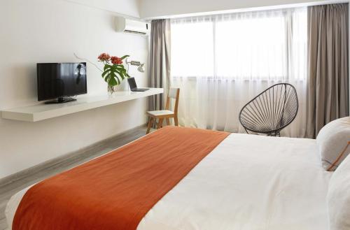 a hotel room with a bed and a tv at Deco Collection in Buenos Aires