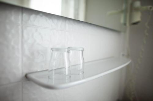 a glass vase sitting on a shelf in a wall at Hotel-Cafe Römer in Siegen