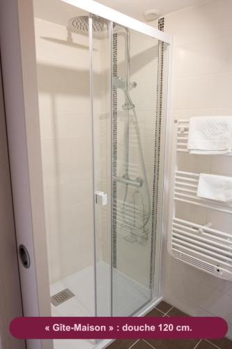 a shower with a glass door in a bathroom at Le Chant des Sources, Gîtes et Chambres d'hôtes avec Vue, à Gimel-les-Cascades in Gimel