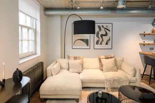 a living room with a couch and a table at Be London - The Southwark Residences in London