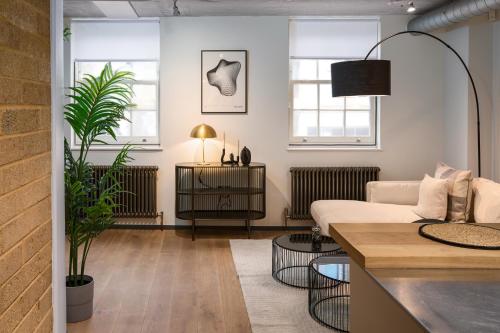 a living room with a couch and a table at Be London - The Southwark Residences in London