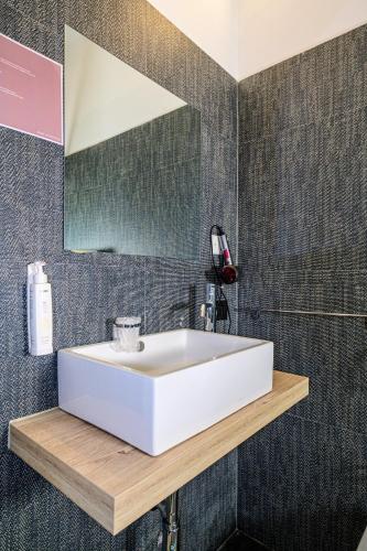 a bathroom with a white sink and a mirror at Vinsea Hotel in Bellaria-Igea Marina