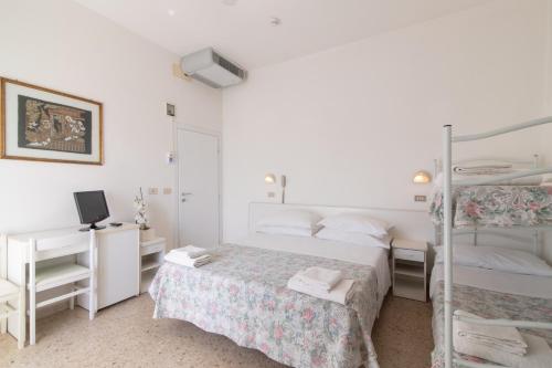 a bedroom with a bed and two bunk beds at Hotel MIRO' in Cattolica