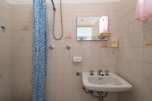 a bathroom with a sink and a shower at Hotel MIRO' in Cattolica