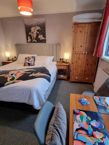 a hotel room with two beds and a table at Pride Lodge in Blackpool