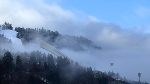 a snowboard flying in the air over a mountain at DAS LUDWIG - Haus HOCHLAND in Garmisch-Partenkirchen
