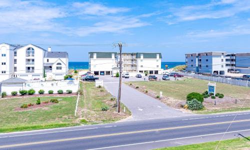 an aerial view of a street with buildings and the ocean at Sunny Delight - KDH MP 7, Ocean View, 130 Yds to Beach, Pool, Hot Tub, Pets OK, Flex Stays in Kill Devil Hills