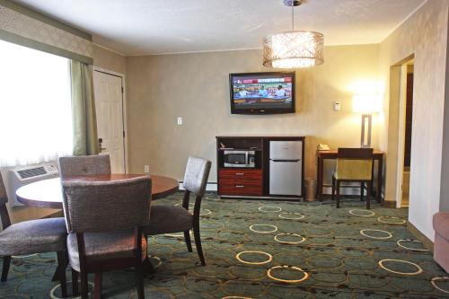 a living room with a table and a dining room at Gateway Inn and Suites in Salida