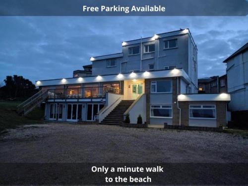 a large white building with stairs to the beach at Mayfair Hotel -Isle of Wight in Shanklin