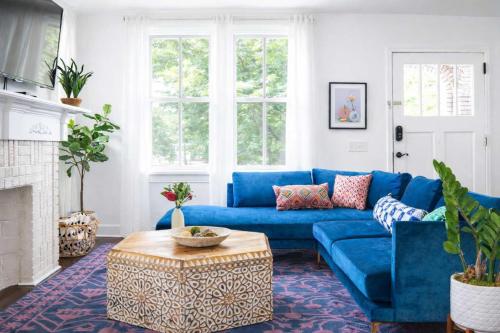 a living room with a blue couch and a table at Parkfront Lux in Atlanta