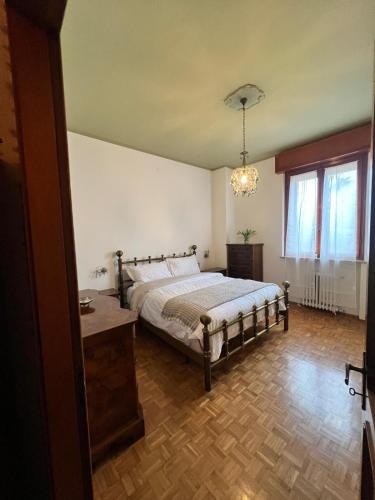 a bedroom with a bed and a chandelier at Da Carmela Italian Home in Mantova