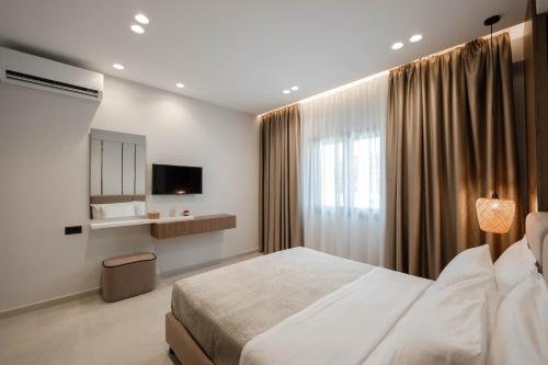 a bedroom with a large bed and a television at Private Villa Ksamil in Ksamil