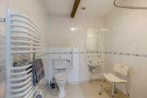 a white bathroom with a toilet and a sink at 2 Bed in Builth Wells oc-39471 in Builth Wells