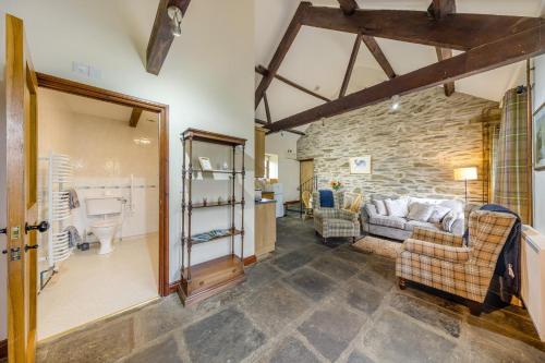 a living room with a couch and a stone wall at 2 Bed in Builth Wells oc-39471 in Builth Wells