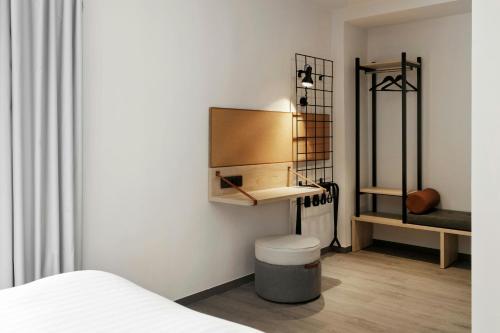a bedroom with a bed and a sink in a room at Moxy Barcelona in Barcelona