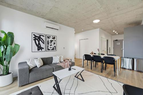 a living room with a couch and a table at Envitae Hotel 4BR Modern Sleek Apartment in Chicago
