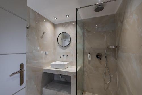 a bathroom with a shower and a sink at Villa Naisy in Tsilivi