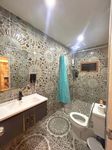 a bathroom with a toilet and a sink at Fora Boutique Hotel in Karon Beach