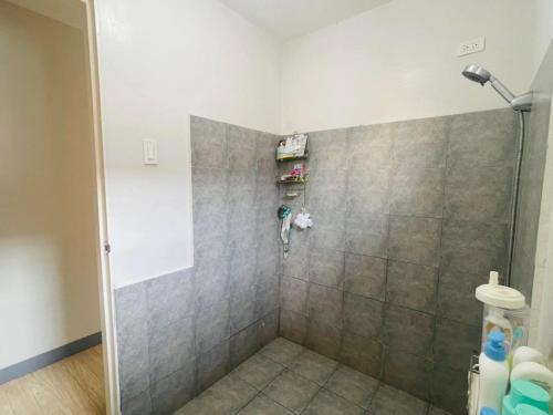 a shower stall in a bathroom with a tile floor at CasaMia in San Pablo