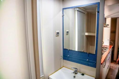 a bathroom with a sink and a mirror at Camping Parc Bellevue - Maeva in Cannes