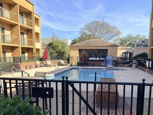 a swimming pool in front of a apartment building at Hotel Preston by IHG in Montgomery