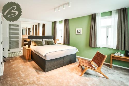 a bedroom with a bed and a chair in it at Bachofer in Waiblingen