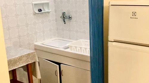 a small kitchen with a sink and a refrigerator at RM06 - Senigallia, trilocale fronte mare in Senigallia