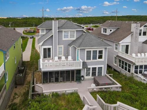 an aerial view of a row of houses at Dunes for Days - Nags Head MP 12.5, Oceanfront, Hot Tub, Rec Room, Pets OK, YR Flex in Nags Head
