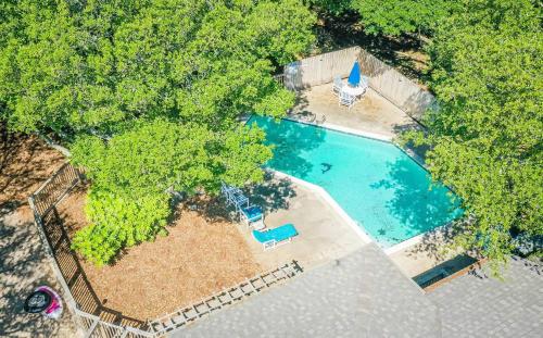 an overhead view of a swimming pool with trees at Seascape Cottage - Kitty Hawk, MP 3.5, 300 Yds to Beach, Pool, Foosball, Near Golf Course, Flex Stays in Kitty Hawk