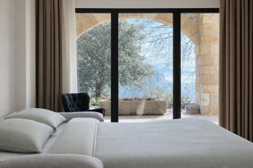 a bedroom with a bed and a large window at El Balcón de Potes in Potes