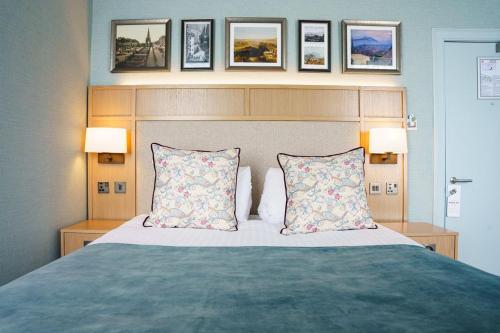 a bedroom with a large bed with two pillows at The Parliament House Hotel in Edinburgh