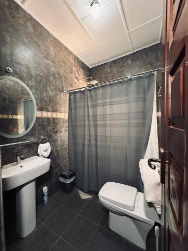 a bathroom with a sink and a toilet and a shower at C&B House MV in Accra