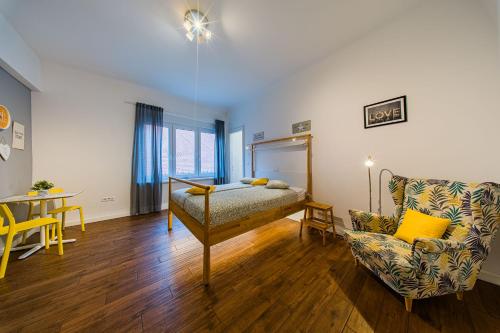 a living room with a couch and a chair at Flex SelfCheckIns 209 - Zagreb - Studio Apartment - Centre in Zagreb