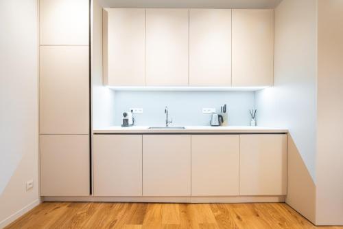 a kitchen with white cabinets and a sink at Vila Dolná in Banská Bystrica