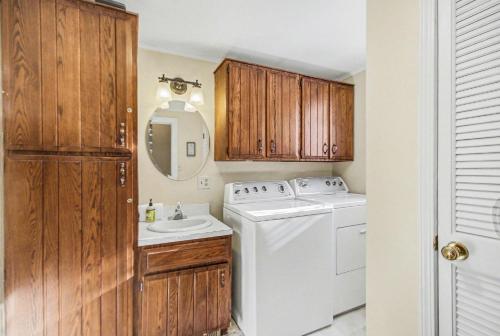 a bathroom with a washing machine and a sink at A Shore Thing in Douglas