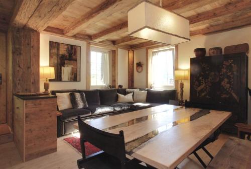 a living room with a couch and a table at Brand new beautiful ground floor flat in Cortina dʼAmpezzo