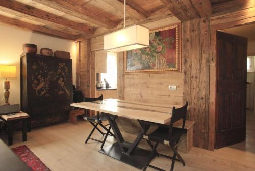 a dining room with a wooden table in a room at Brand new beautiful ground floor flat in Cortina dʼAmpezzo
