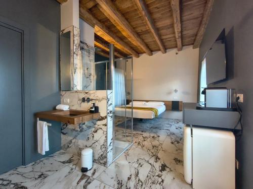 a hotel room with a marble floor and a bedroom at Vulcano Palace in Castro