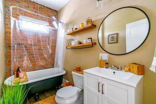 a bathroom with a sink toilet and a mirror at The Parkside by Jungle House - Short North Boutique Suites in Columbus