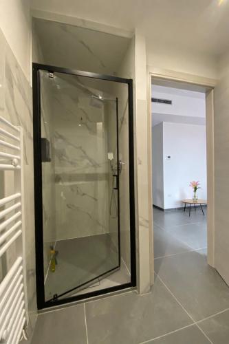 a glass shower in a room with a hallway at Il Sogno in Como