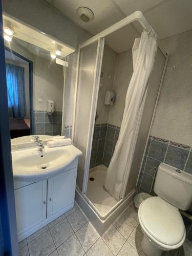 a bathroom with a sink and a toilet and a shower at Hôtel & Résidence Avermes in Avermes
