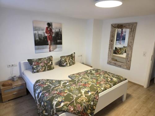 a bedroom with a bed and a picture on the wall at Bodensee Ferienwohnung Claudia 4 in Friedrichshafen