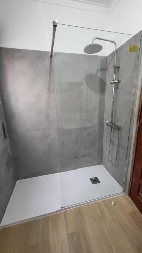 a shower with a glass door in a bathroom at Double Room near Sintra & Lisbon in Queluz