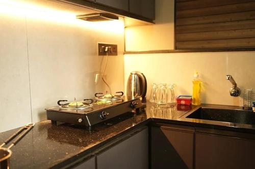 a kitchen with a stove top on a counter at Winter Whisper in Jāmb