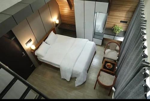 a bedroom with a white bed and a chair at Winter Whisper in Jāmb