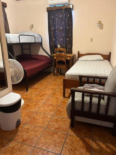 a living room with two beds and a couch at Don Santiago Guesthouse Downtown in San Ignacio