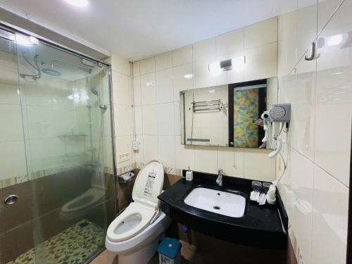 a bathroom with a toilet and a sink and a shower at Kim's Home in Ba Dinh in Hanoi