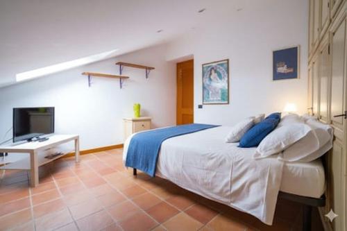 a bedroom with a bed and a desk and a television at La Dimora Dei Cimini in Caprarola