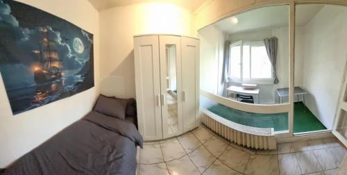 a small room with a bed and a window at Geneva House M in Ferney-Voltaire