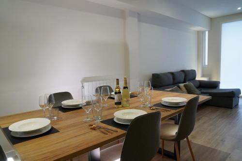 a dining room table with wine bottles and glasses at Casa Dolce Casa - Elegant 3BR Apartment Near Metro & Beach,Valencia in Valencia
